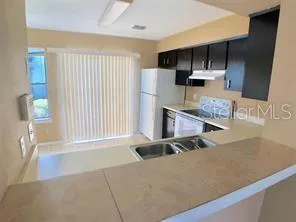 a kitchen with stainless steel appliances a microwave a sink and a refrigerator