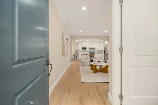 a view of a living room with a sink and wooden floor