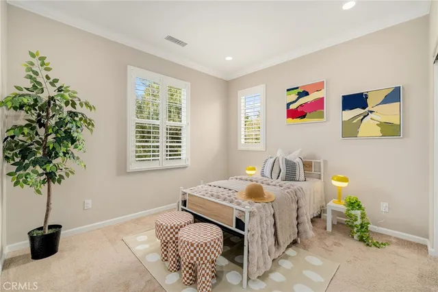 a bedroom with a bed and a potted plant