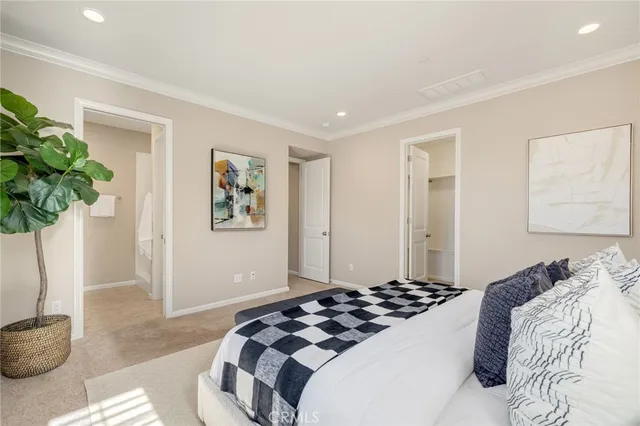 a bedroom with a bed and a potted plant