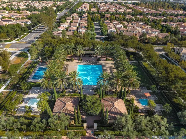 an aerial view of residential houses with outdoor space and trees