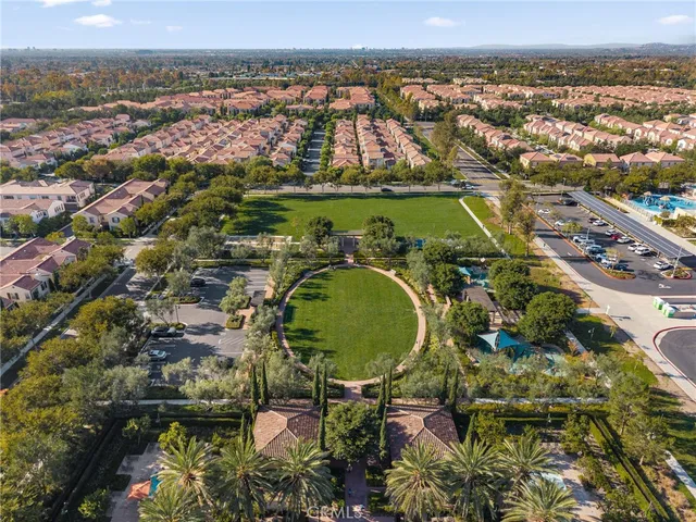 an aerial view of residential houses with outdoor space and swimming pool