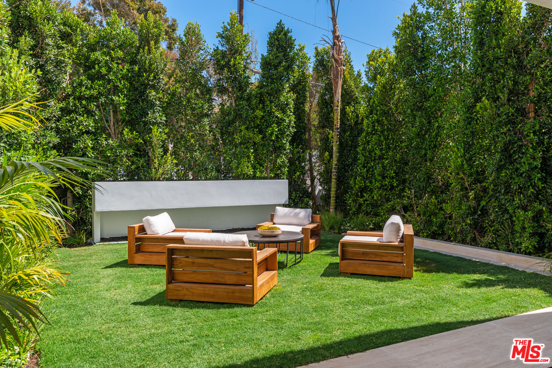 27234 Pacific Coast Highway Malibu, CA 90265 - Photo 16 of 54 a backyard of a house with a bench and trees