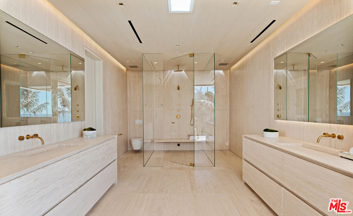 27234 Pacific Coast Highway Malibu, CA 90265 - Photo 26 of 54 a spacious bathroom with a tub a double vanity sink and mirror