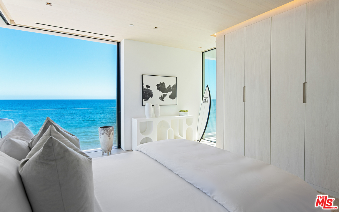 27234 Pacific Coast Highway Malibu, CA 90265 - Photo 33 of 54 a bedroom with a bed and a painting on the wall
