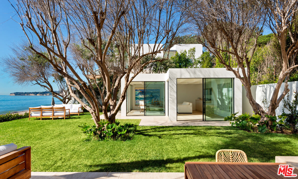 27234 Pacific Coast Highway Malibu, CA 90265 - Photo 44 of 54 a view of a house with backyard sitting area and garden
