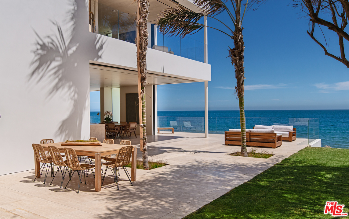 27234 Pacific Coast Highway Malibu, CA 90265 - Photo 6 of 54 a backyard of a house with table and chairs
