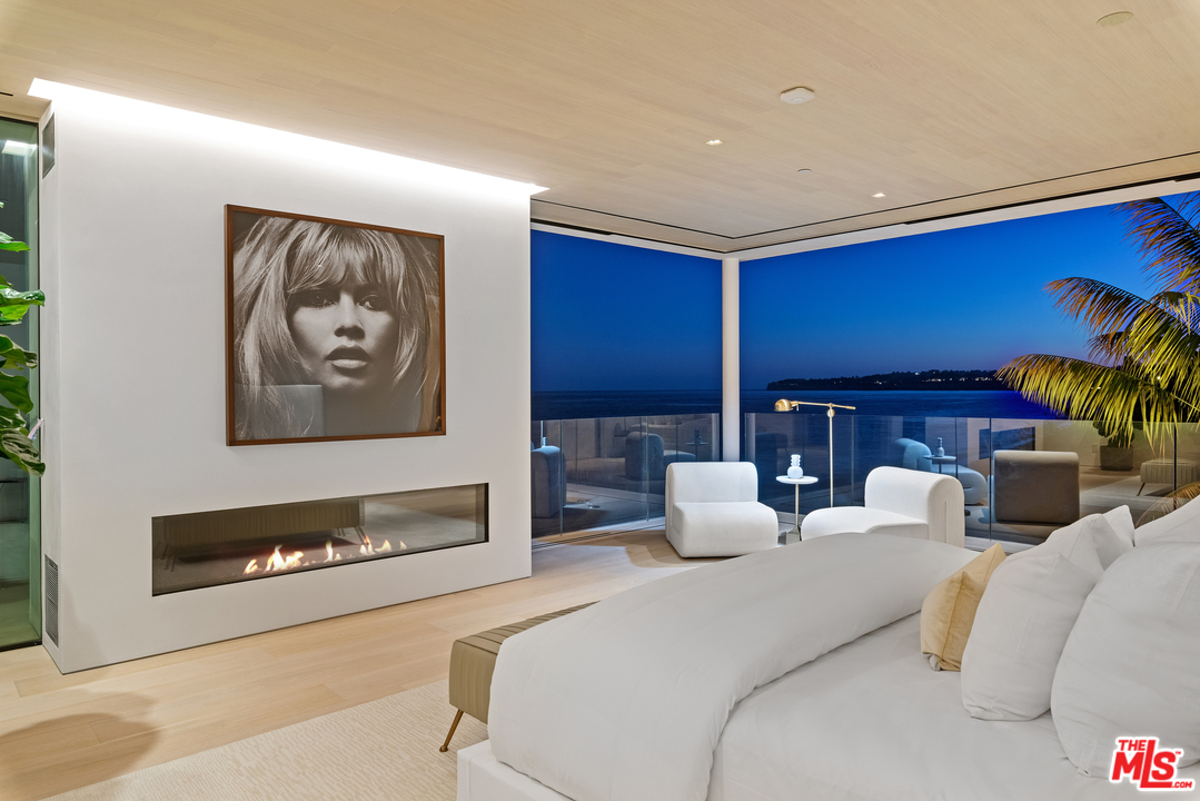 27234 Pacific Coast Highway Malibu, CA 90265 - Photo 53 of 54 a bedroom with furniture and a fireplace