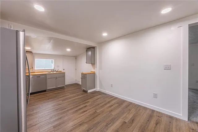 a view of a kitchen with a sink and a refrigerator