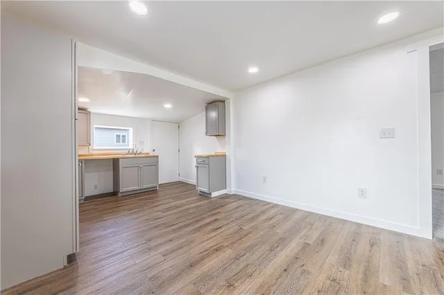 a view of a kitchen with a sink and a refrigerator