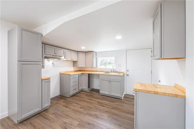 a kitchen with a refrigerator sink and cabinets