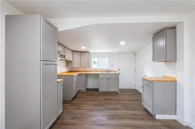 a kitchen with a refrigerator and a sink