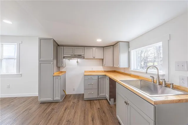 a kitchen with wooden cabinets a sink stove and refrigerator