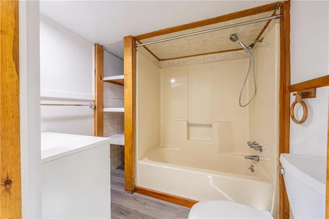 a bathroom with a shower and a bath tub