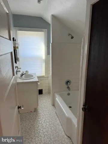 a bathroom with a bathtub a sink and a shower