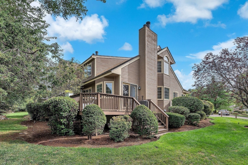 5 Weybridge Lane, Unit 5 Hopkinton, MA 01748 - Photo 1 of 34 a view of a house with a yard and plants