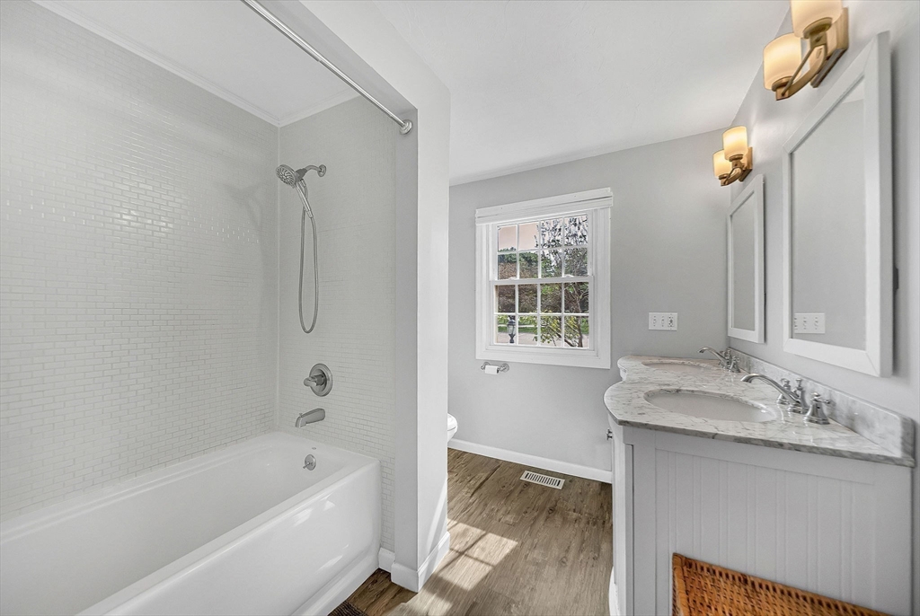 5 Weybridge Lane, Unit 5 Hopkinton, MA 01748 - Photo 12 of 34 a bathroom with a tub sink and mirror