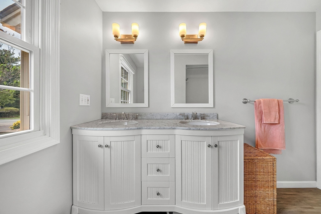 5 Weybridge Lane, Unit 5 Hopkinton, MA 01748 - Photo 13 of 34 a bathroom with a granite countertop sink and a mirror