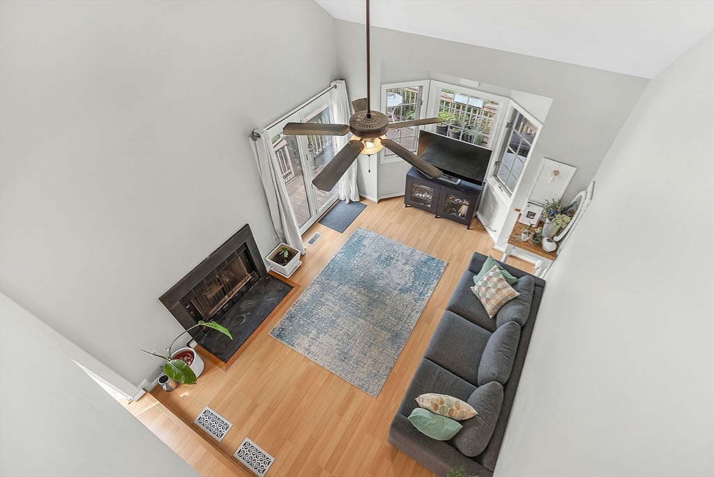 5 Weybridge Lane, Unit 5 Hopkinton, MA 01748 - Photo 19 of 34 a living room with furniture and a wooden floor