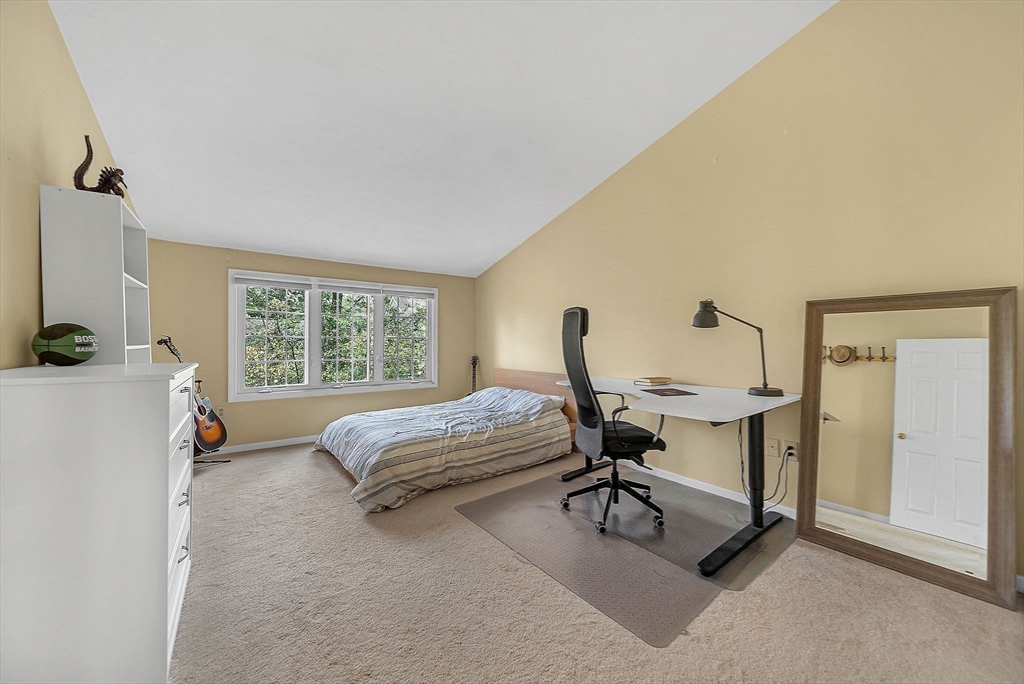 5 Weybridge Lane, Unit 5 Hopkinton, MA 01748 - Photo 20 of 34 a bedroom with a bed and a table