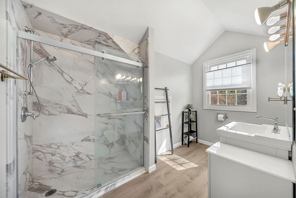 5 Weybridge Lane, Unit 5 Hopkinton, MA 01748 - Photo 21 of 34 a bathroom with a sink and a mirror