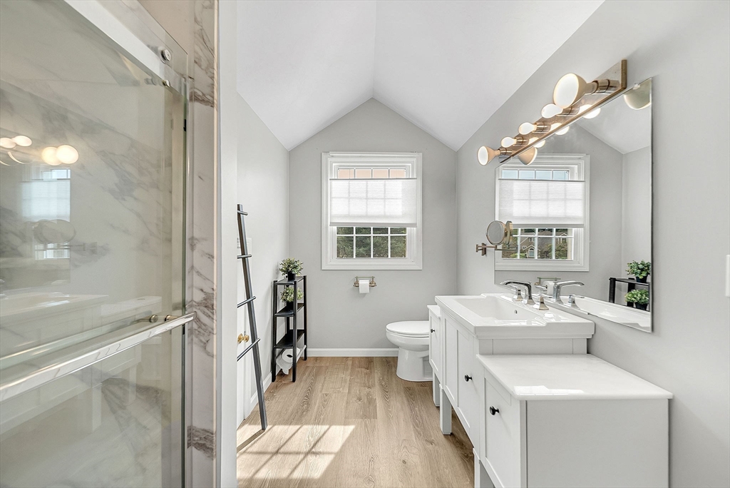 5 Weybridge Lane, Unit 5 Hopkinton, MA 01748 - Photo 24 of 34 a bathroom with a sink a toilet and a mirror