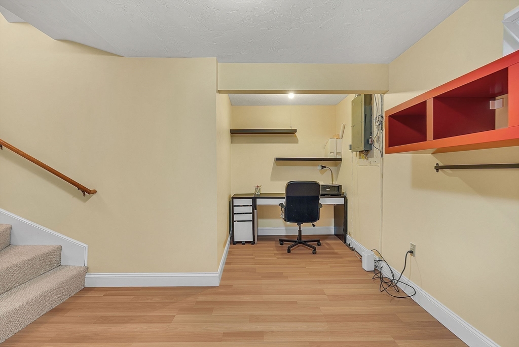 5 Weybridge Lane, Unit 5 Hopkinton, MA 01748 - Photo 25 of 34 a view of a livingroom with lounge chair and piano