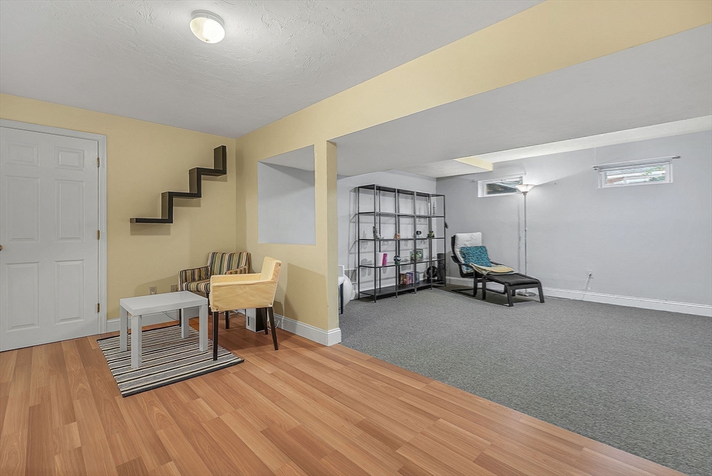 5 Weybridge Lane, Unit 5 Hopkinton, MA 01748 - Photo 26 of 34 a living room with furniture and a wooden floor