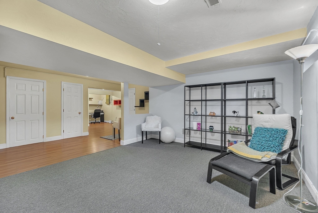 5 Weybridge Lane, Unit 5 Hopkinton, MA 01748 - Photo 28 of 34 a living room with furniture