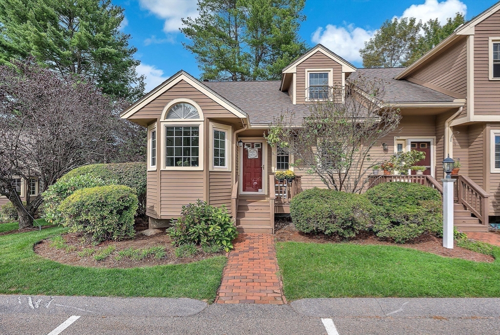 5 Weybridge Lane, Unit 5 Hopkinton, MA 01748 - Photo 33 of 34 a front view of a house with a yard and trees