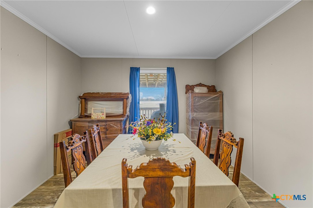 2610 Wendel Road Meyersville, TX 77974 - Photo 12 of 29 a view of a dining room with furniture a rug and wooden floor