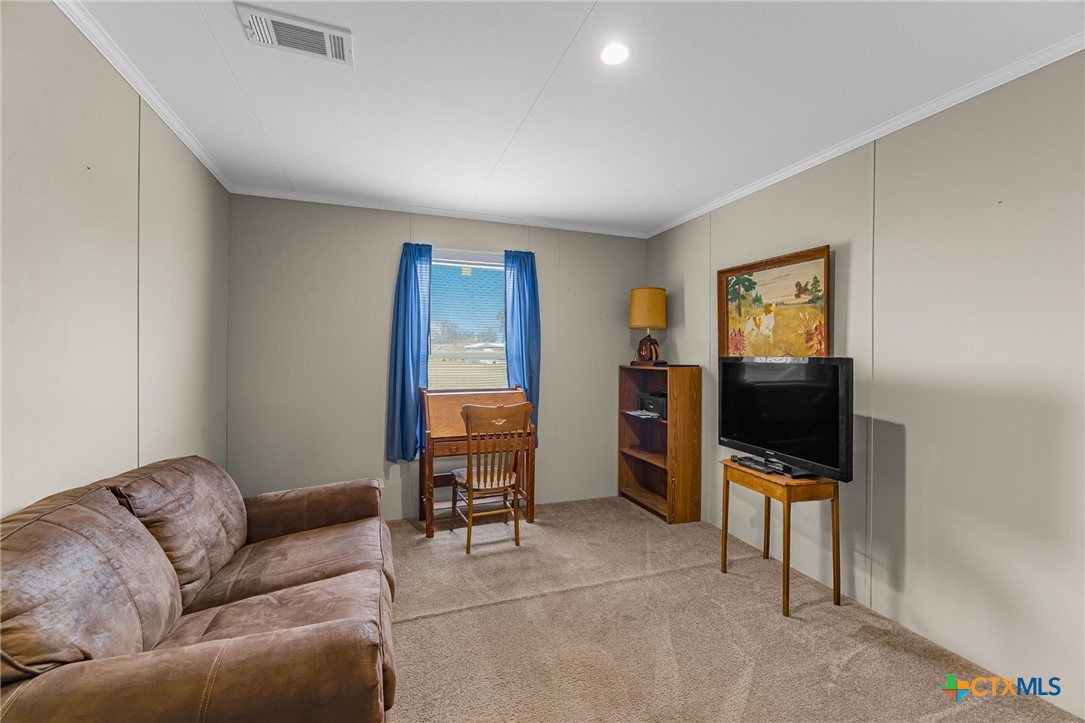 2610 Wendel Road Meyersville, TX 77974 - Photo 13 of 29 a living room with furniture and a flat screen tv