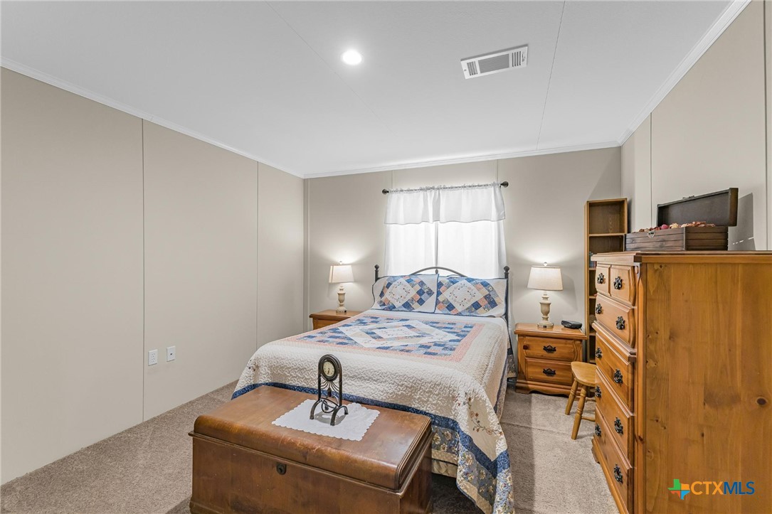 2610 Wendel Road Meyersville, TX 77974 - Photo 14 of 29 a bedroom with a bed and a table