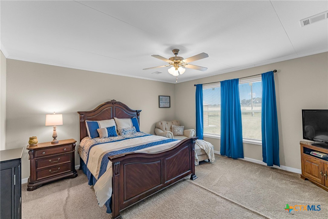2610 Wendel Road Meyersville, TX 77974 - Photo 17 of 29 a bedroom with a bed chandelier and a window