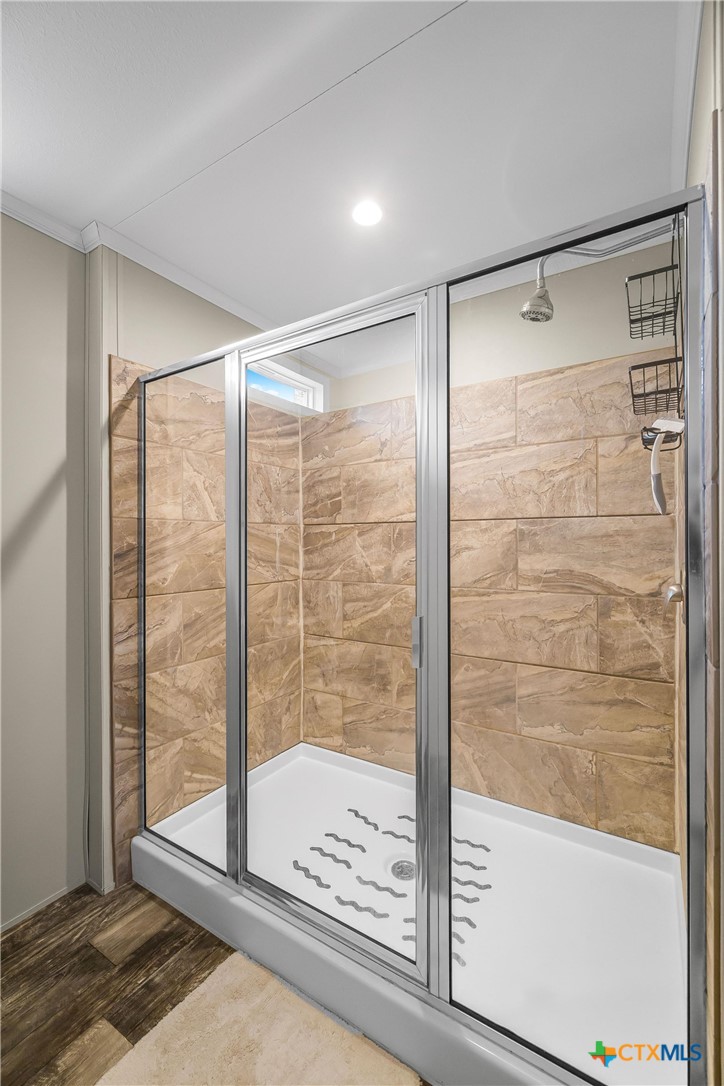 2610 Wendel Road Meyersville, TX 77974 - Photo 20 of 29 a bathroom with a glass shower door