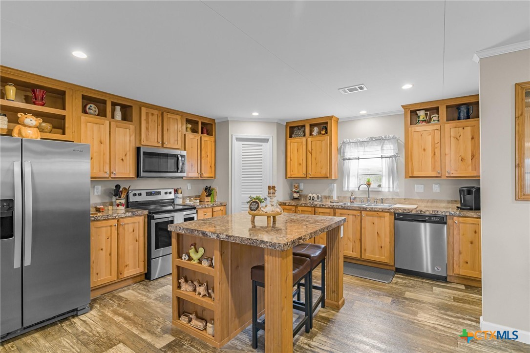 2610 Wendel Road Meyersville, TX 77974 - Photo 7 of 29 a kitchen with stainless steel appliances granite countertop a sink stove refrigerator and cabinets