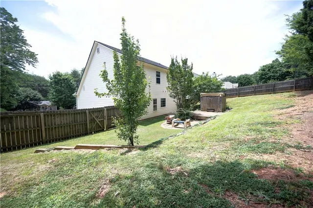 a view of a house with backyard porch and sitting area