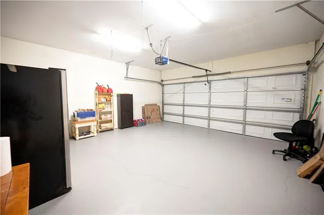 an aerial view of residential house with outdoor space and trees all around