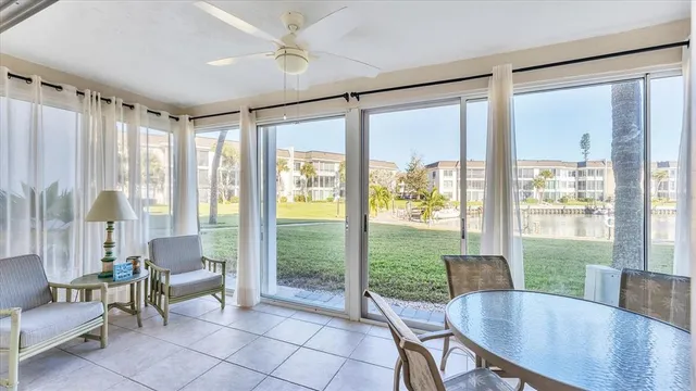 a view of a dining room with furniture large windows and wooden floor