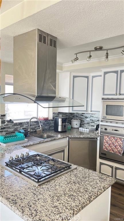 14515 Rivers Edge Road Helendale, CA 92342 - Photo 8 of 16 a kitchen with stainless steel appliances granite countertop a sink and cabinets