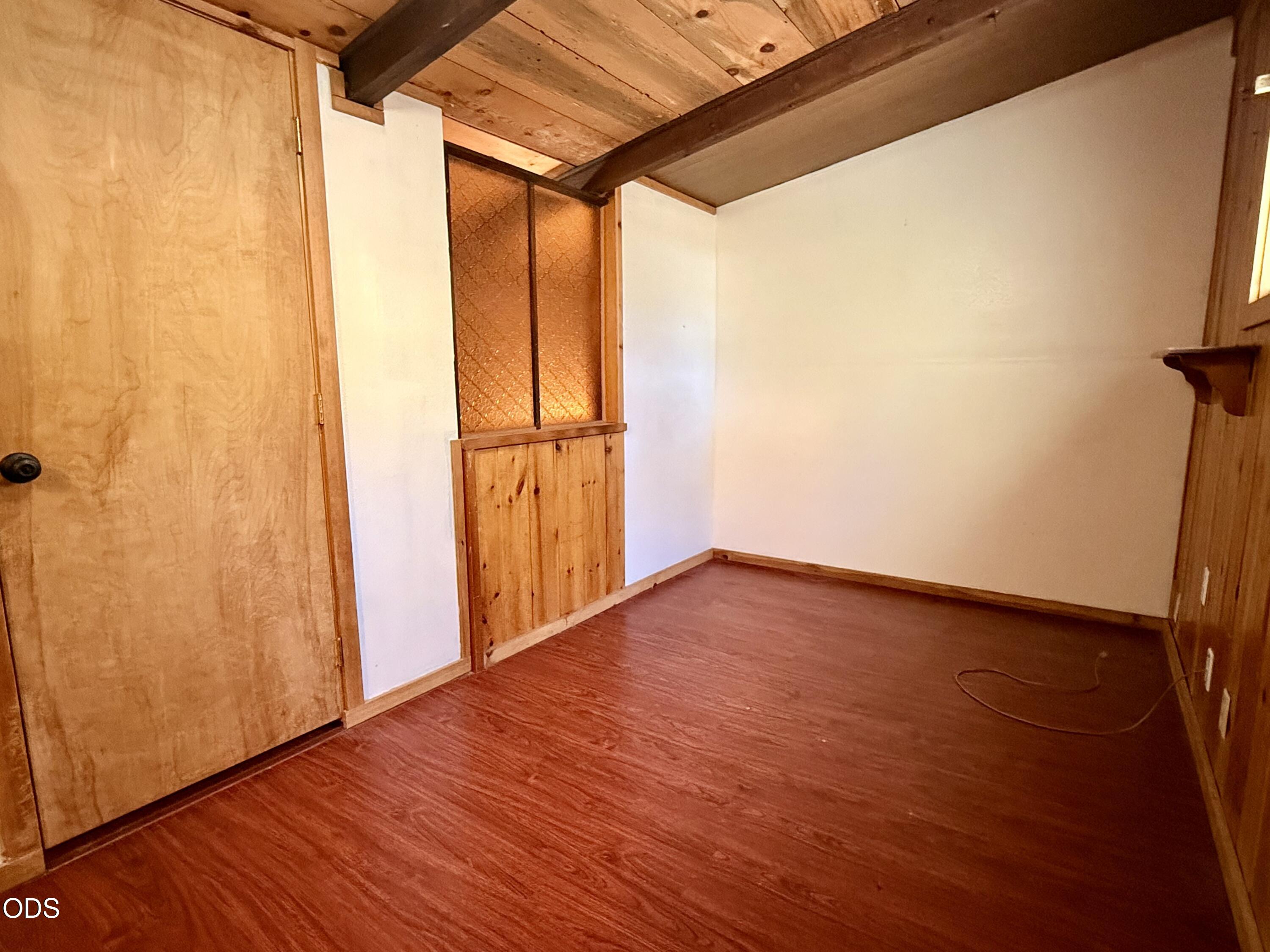 16025 Strawn Road La Pine, OR 97739 - Photo 32 of 95 a view of an empty room with wooden floor and a window