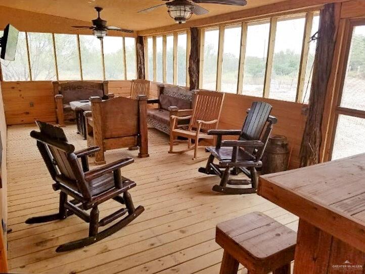 2938 Highway 83 Roma, TX 78584 - Photo 17 of 23 Sunroom / solarium featuring wooden walls and hardwood / wood-style floors