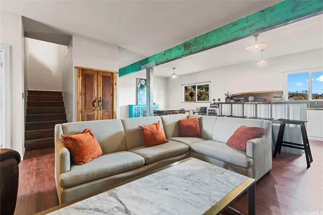 a living room with furniture or couch and a wooden floor