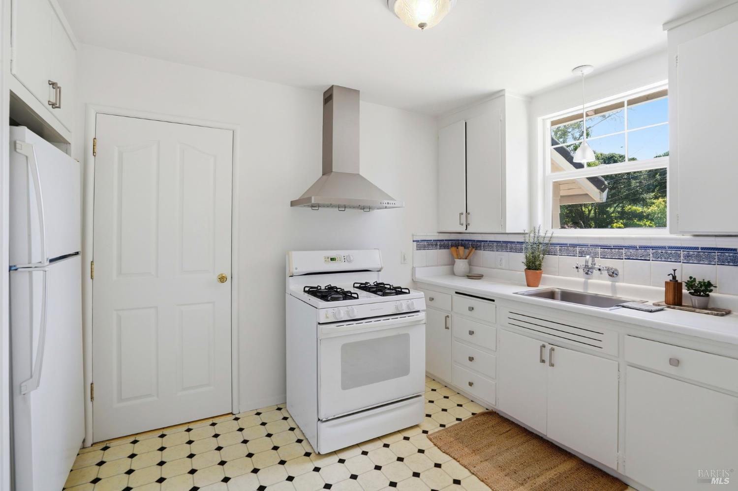 234 Solano Street San Rafael, CA 94901 - Photo 15 of 24 a kitchen with white cabinets and white appliances
