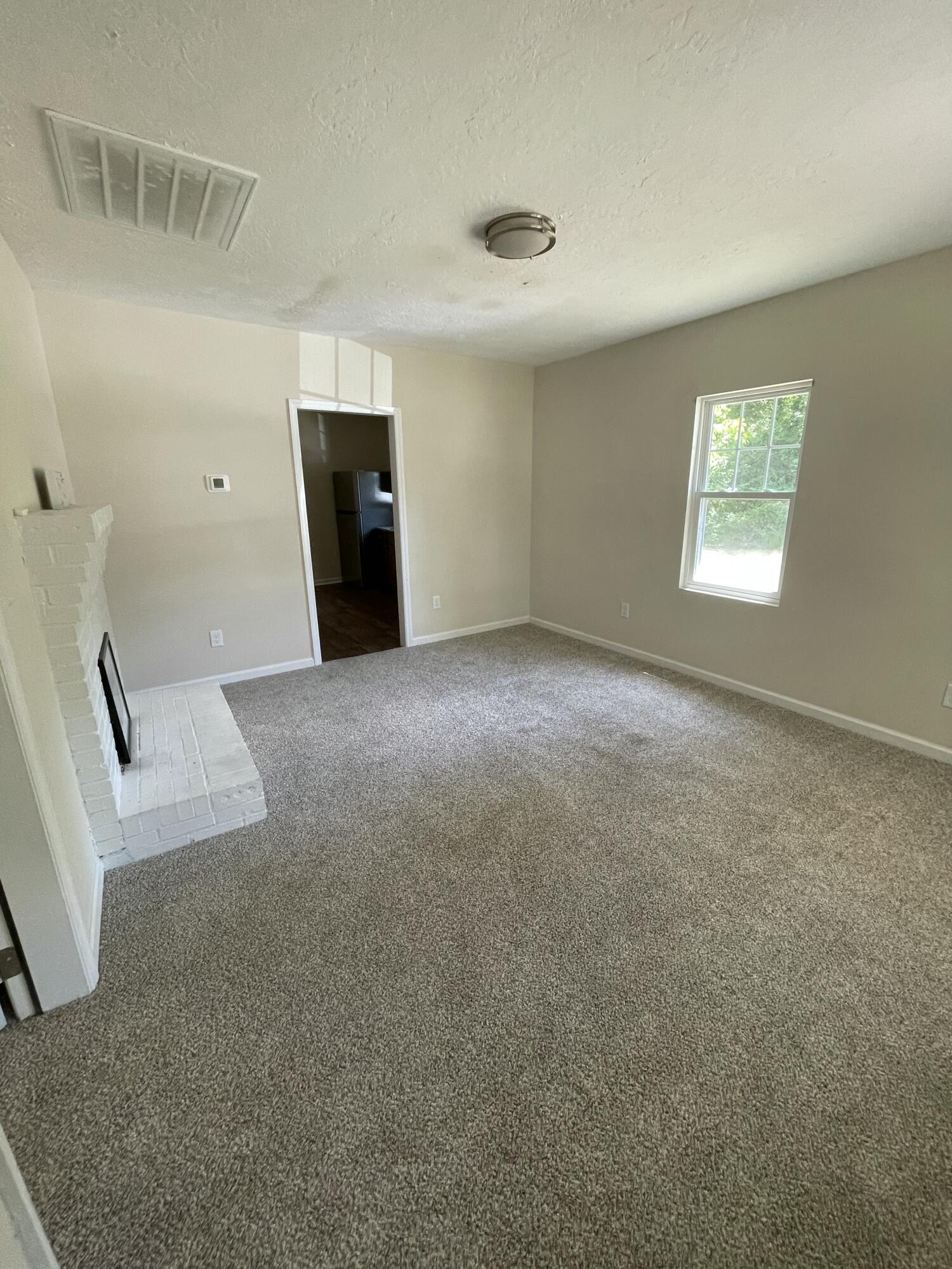 124 West Street Thomson, GA 30824 - Photo 4 of 13 Living Room Fireplace
