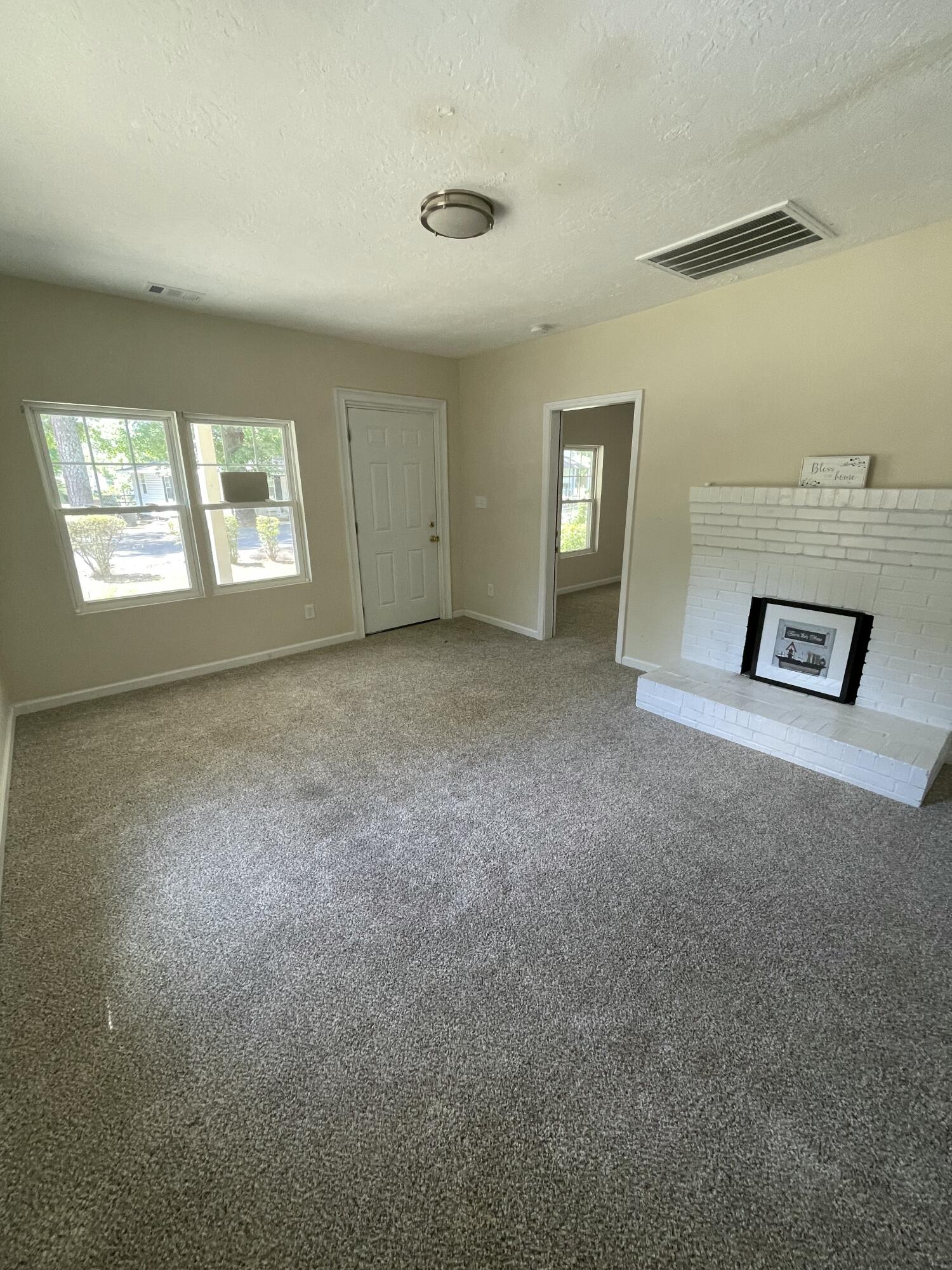 124 West Street Thomson, GA 30824 - Photo 5 of 13 Living Room Fireplace Front Door