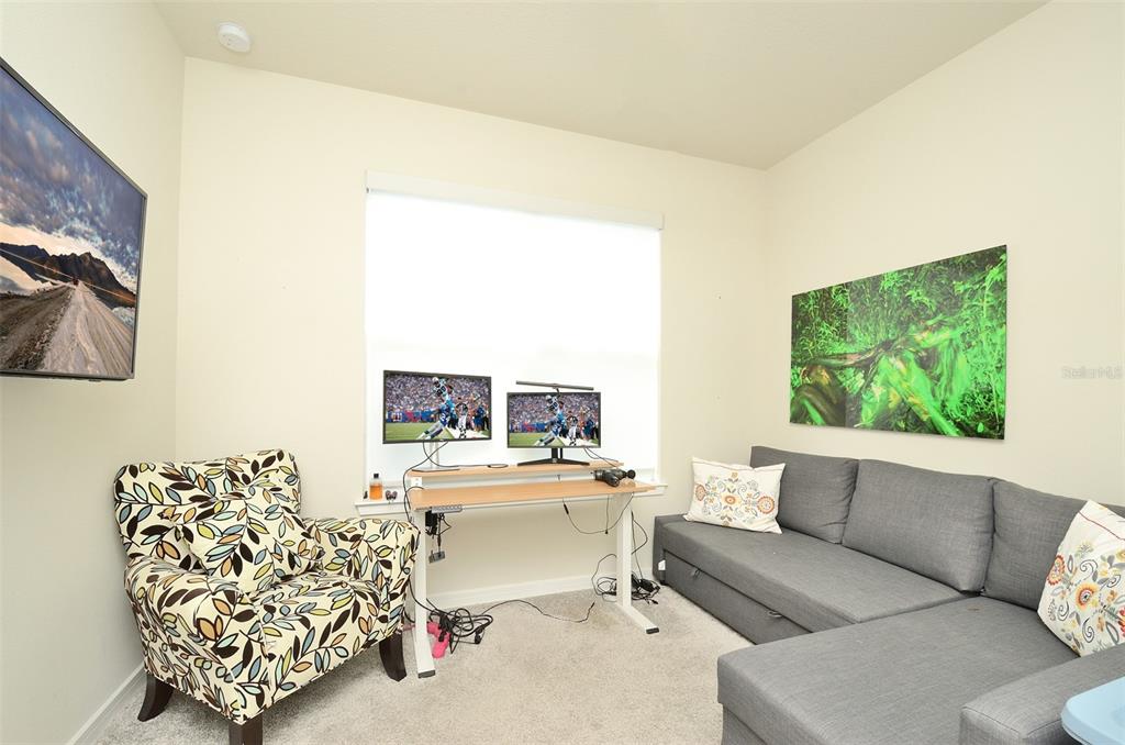 4963 Royal Point Avenue Kissimmee, FL 34746 - Photo 12 of 27 a living room with furniture and a flat screen tv