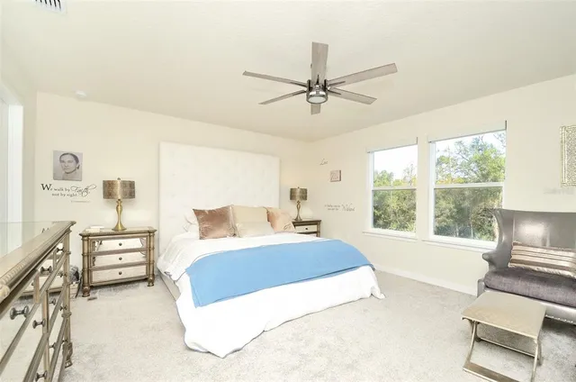 a living room with a bed furniture and a large window