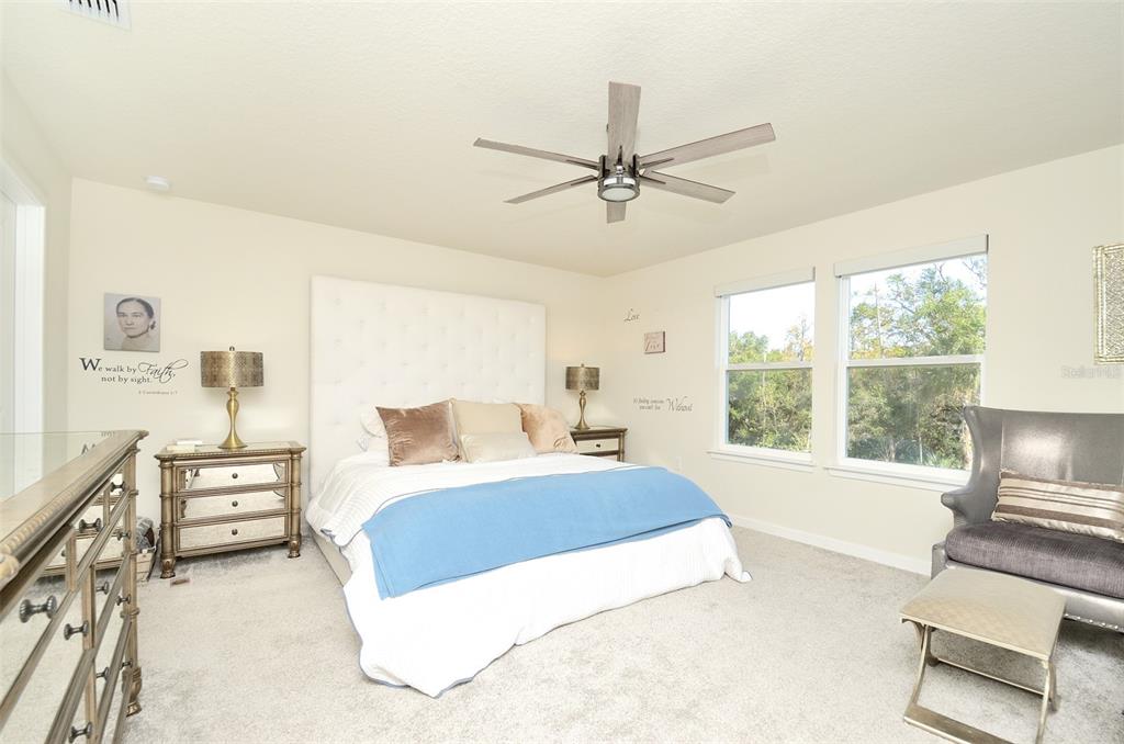 4963 Royal Point Avenue Kissimmee, FL 34746 - Photo 15 of 27 a living room with a bed furniture and a large window