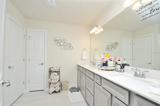 a bathroom with a double vanity sink mirror and shower